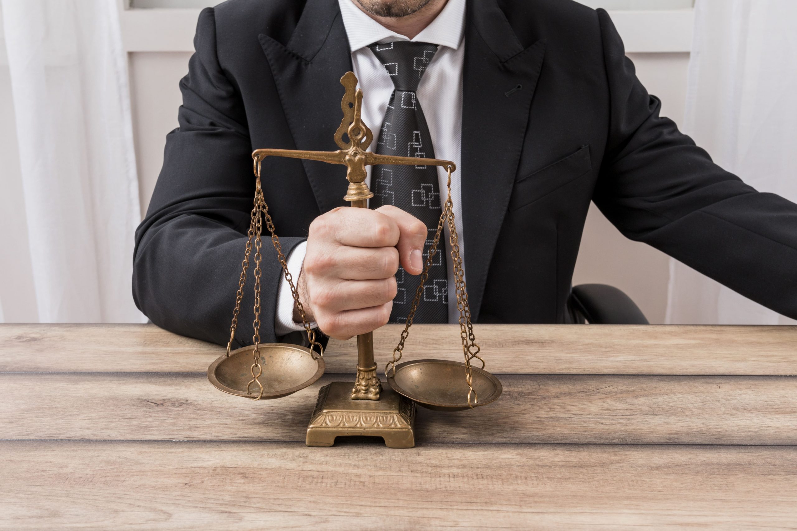 lawyer-with-weighing-scales-min lawyer-with-weighing-scales-min